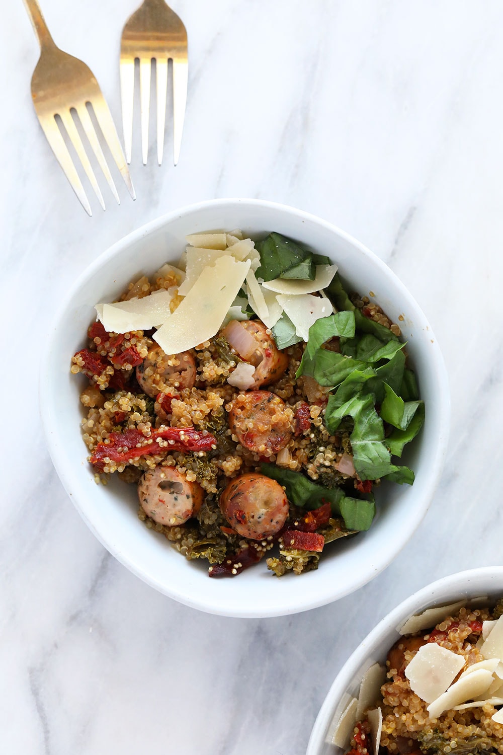 One of our most popular quinoa casserole recipes is this Italian Chicken Sausage Quinoa Casserole. It's protein-packed and made with sun-dried tomatoes and kale! quinoa casserole in bowl