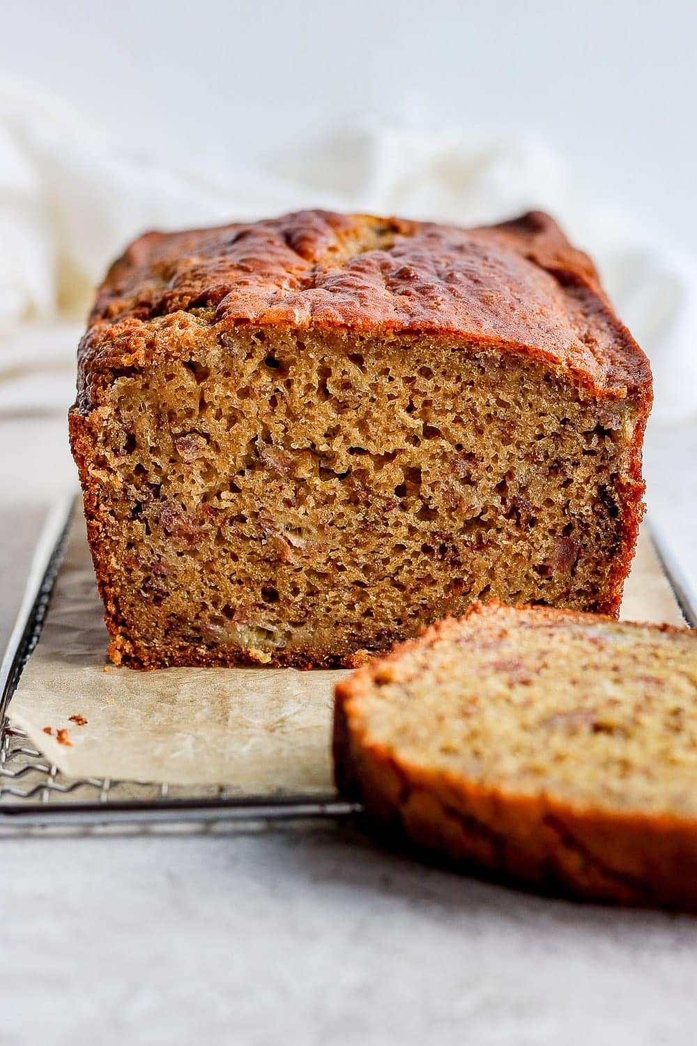 The best healthy banana bread recipe on the internet is right here! It's made with 100% whole grains, all-natural sugars, and coconut oil. Make it today! loaf of banana bread with a slice cut out