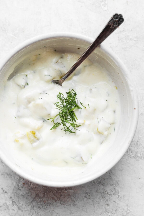 A bowl of yogurt with dill.