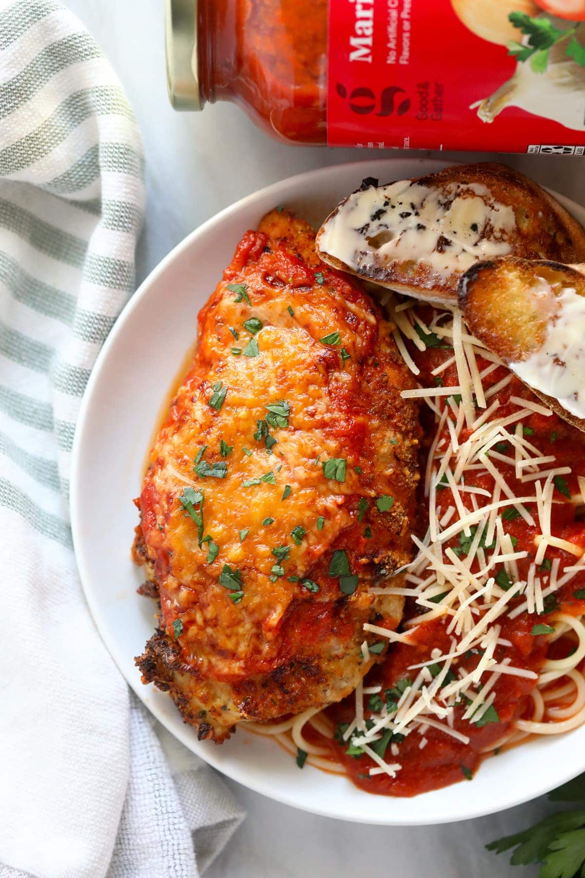 This air fryer chicken parmesan takes no time to whip up and only requires 5 main ingredients. Bonus - there is no oil involved! chicken parmesan on plate with pasta