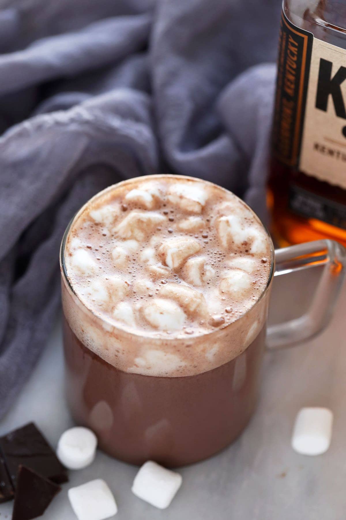 Sip on a mug of this 5-ingredient Easy Spiked Hot Chocolate topped with mini marshmallows. It truly is the perfect winter drink! easy spiked hot chocolate in a mug