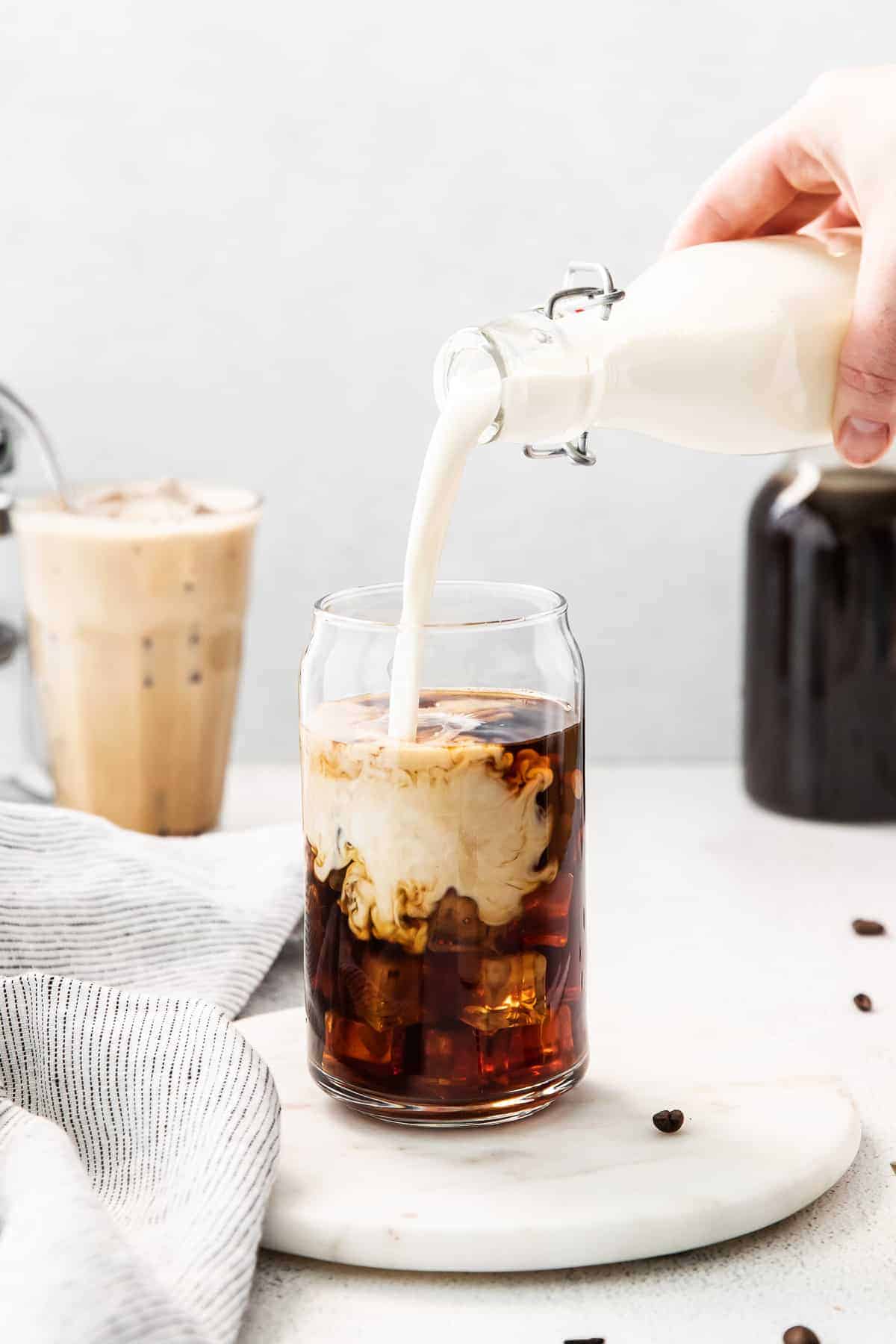 Pouring sweet cream into cold brew.