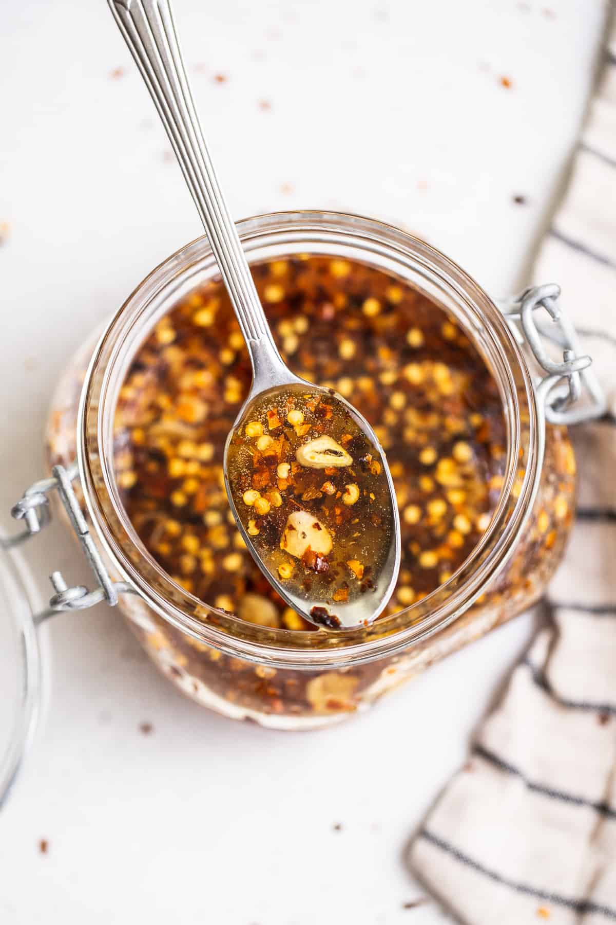 Our 4-ingredient hot honey sauce is hot, sticky and a little sweet. It's the perfect sauce to drizzle over chicken, seafood, pizza, roasted veggies and more! Hot honey on a spoon.
