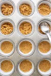 adding crust into muffin tin.