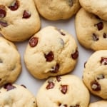 A group of chocolate chip cookies on a white surface.