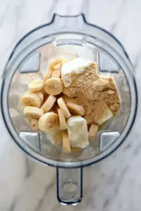 A blender filled with bananas and other ingredients, creating a delicious banana protein shake.